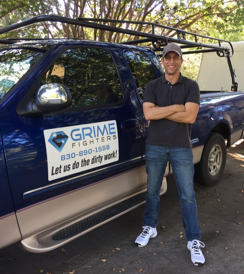 About Grime Fighters - Josh Puccio, Owner standing in front of branded Grime Fighters truck